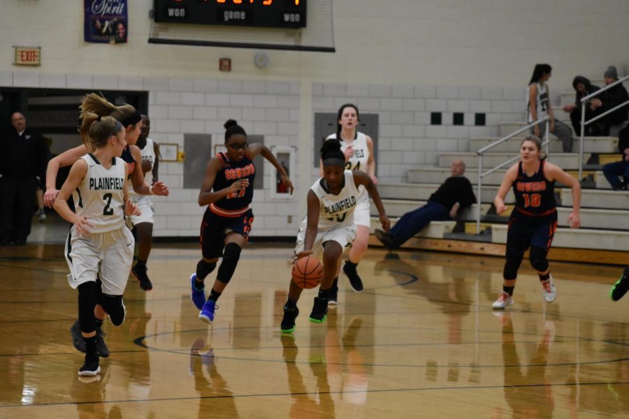 Kachae Donald, junior, brings the ball down the court to set up the offense against Oswego.  The Wildcats  lost 52-72.