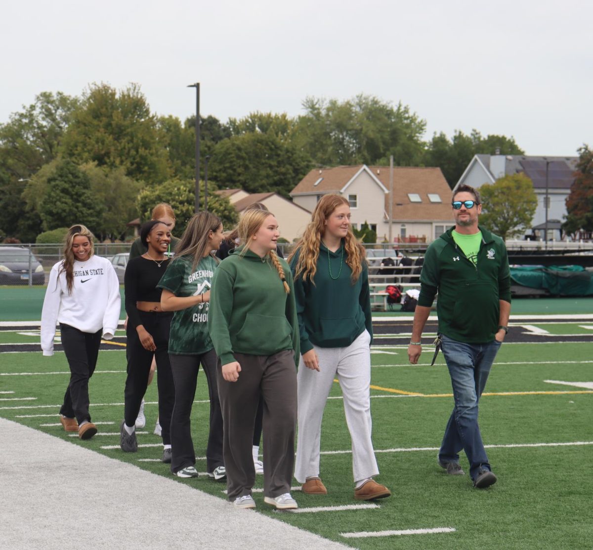 Girls Volleyball Team walking down the field.