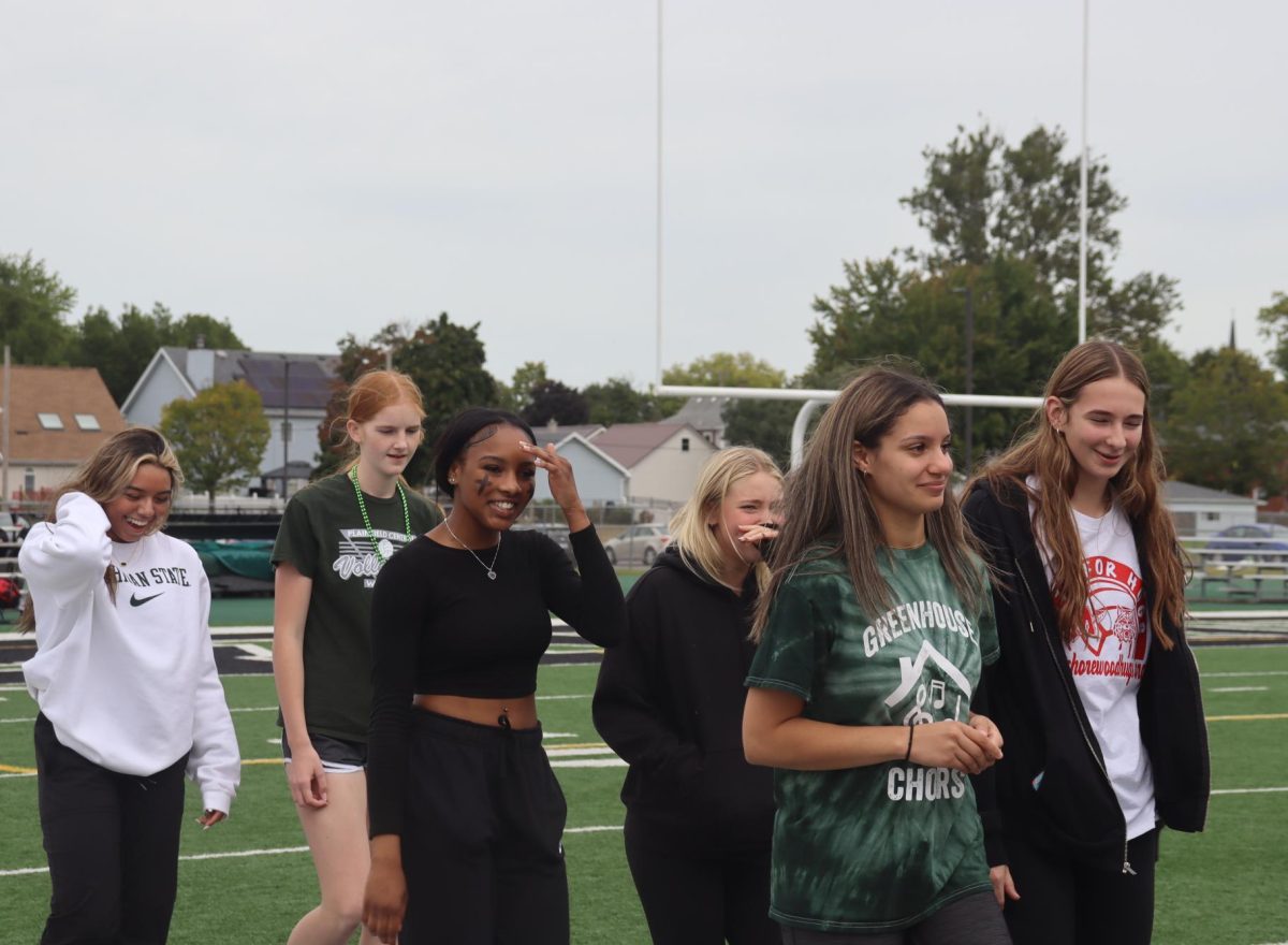 Girls Volleyball Team walking down the field.