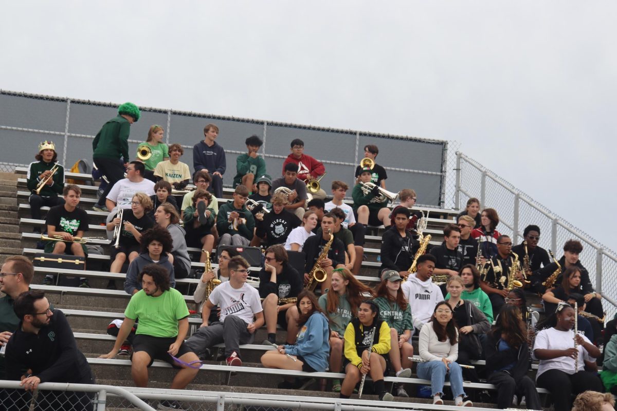 The Band sitting in the bleachers resting before performing at the Pep rally.