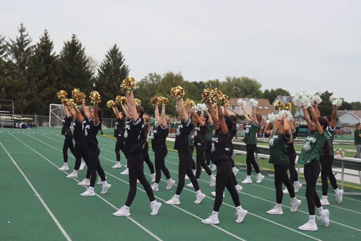 The Poms team pumps up the crowd during the Pep rally.