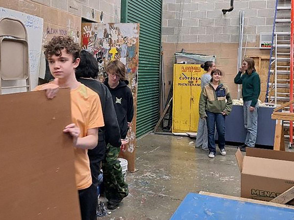 Members of construction crew begin work on the large set pieces for "She Kills Monsters."