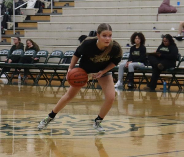 Delaney Weber, junior, drives the ball down the court during the Green and White night scrimmage Nov. 15.