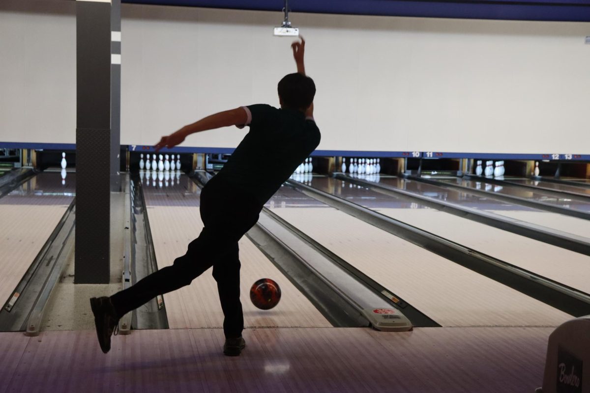 Ethan Evans, senior, attempts to deliver a strike vs. Plainfield North on Dec. 3. Central wins game 1.