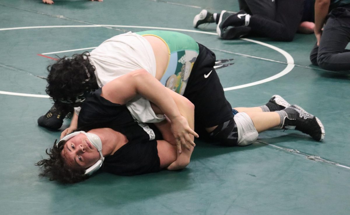 Antonio Montoya, senior, pins Anthony Minnito, senior, during a practice round on Wed. Jan. 22