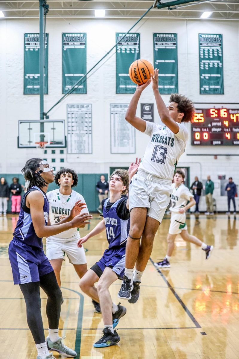 Phoenix Jones, junior, shoots over the Plainfield South opponent, in their 24-67 loss on Dec. 13.